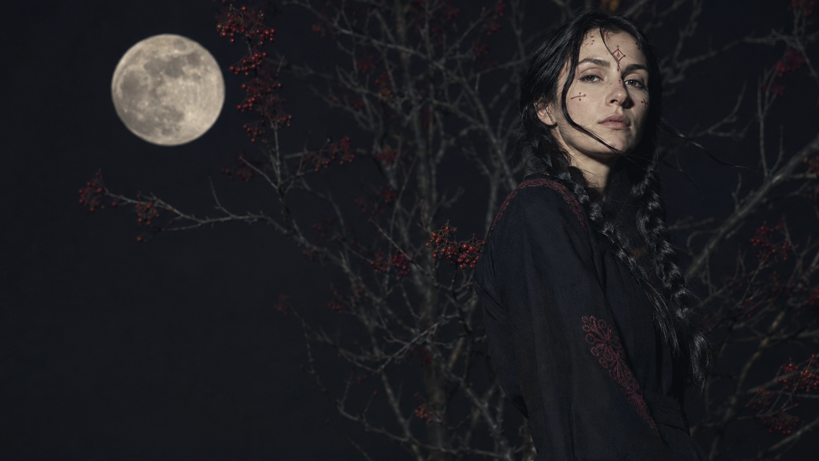 Woman beneath a moon and rowan tree